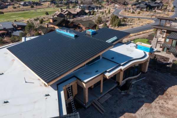 Completed black metal roof panels on custom home